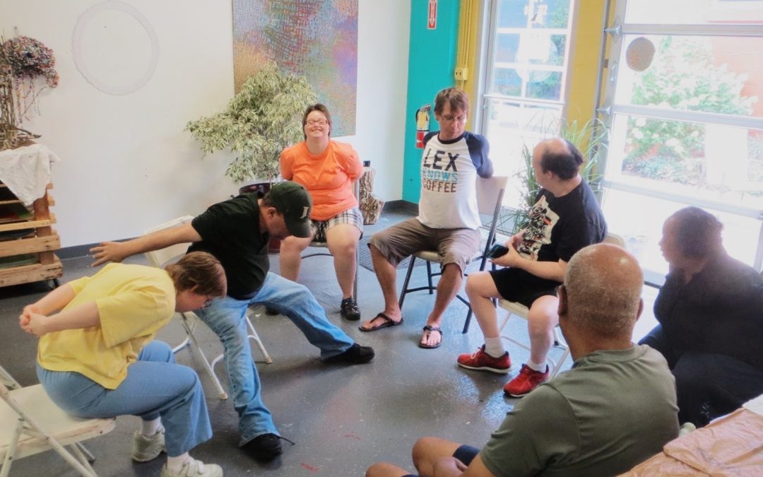 Joshua and his students do chair yoga at latitude arts