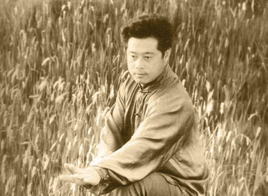 sepia tone photo of ding mingye practicing taiji in a cornfield
