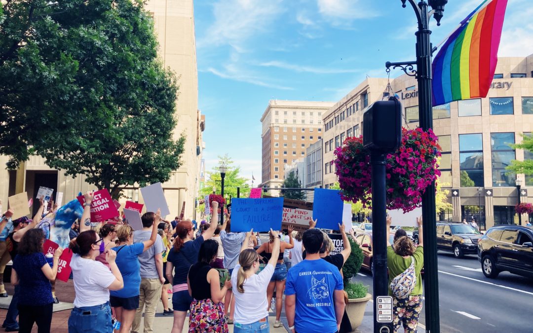people of all kinds holding signs on main street at the sexual rights rally in lexington, ky